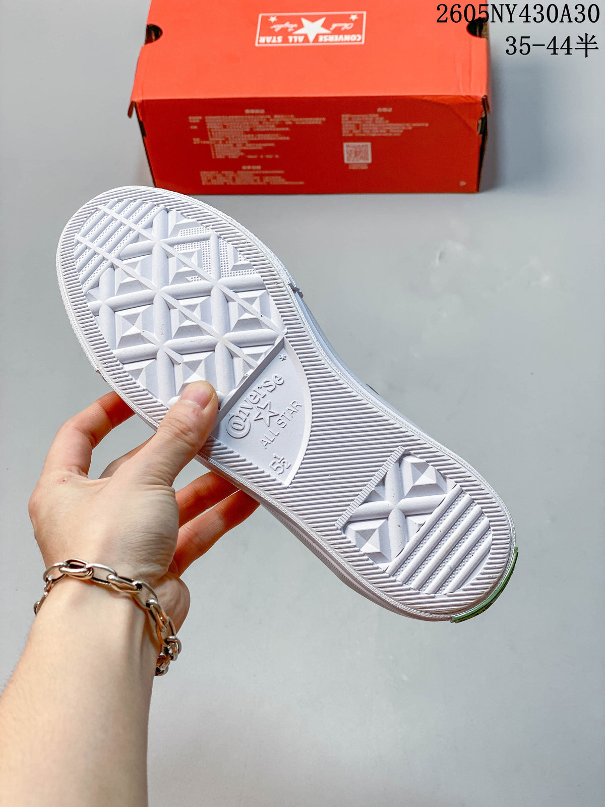 Underside of a Converse sneaker showing the patterned white outsole