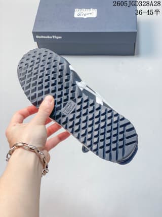 Close view of the patterned outsole on a navy Onitsuka Tiger sneaker