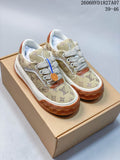Pair of beige monogram low-top sneakers with cream laces, white midsoles, and gum-brown outsoles.