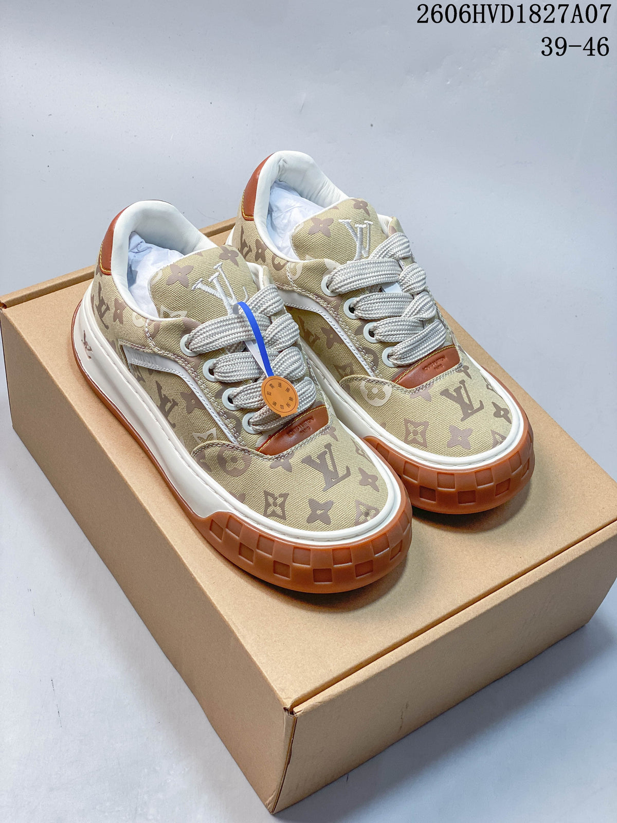 Pair of beige monogram low-top sneakers with cream laces, white midsoles, and gum-brown outsoles.