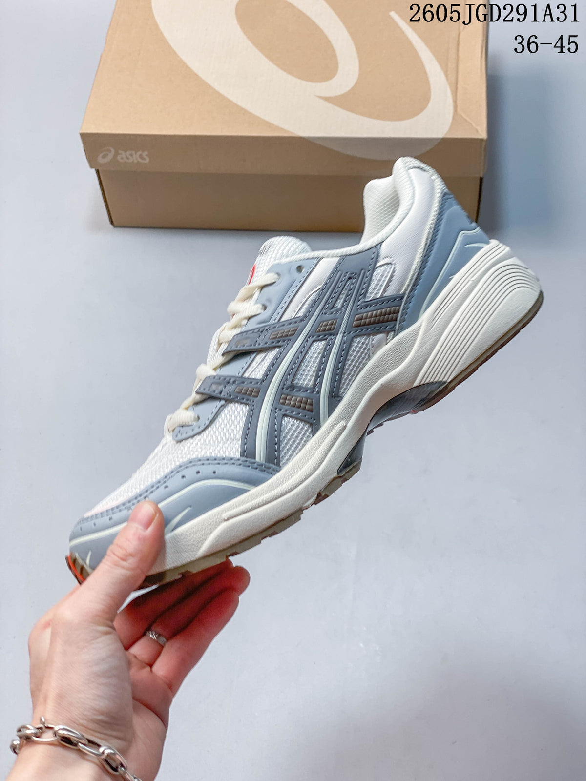 Side view of a white and blue-gray sneaker with layered overlays.