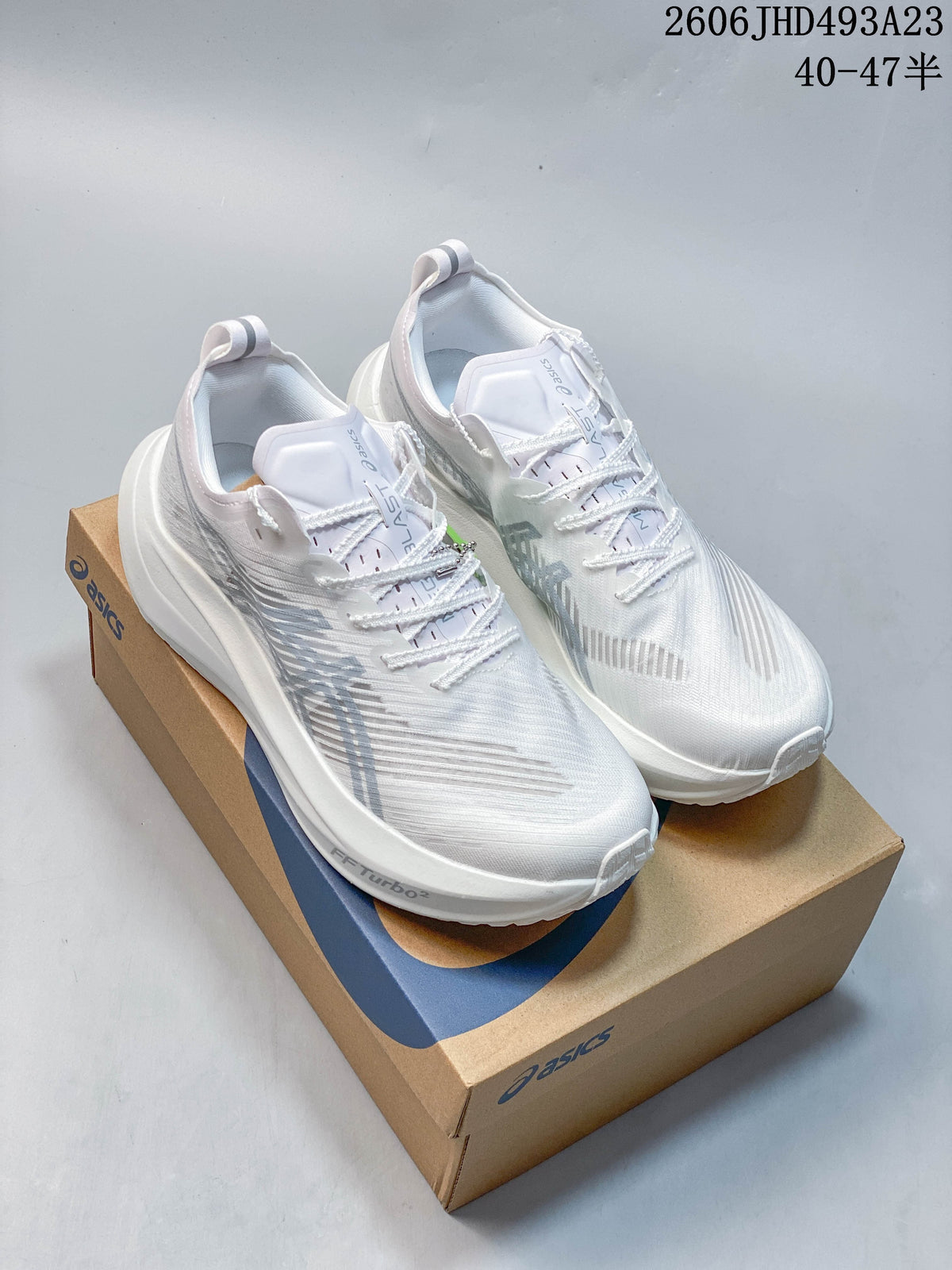 White ASICS MAGIC SPEED FF TURBO running shoes displayed on a shoe box.