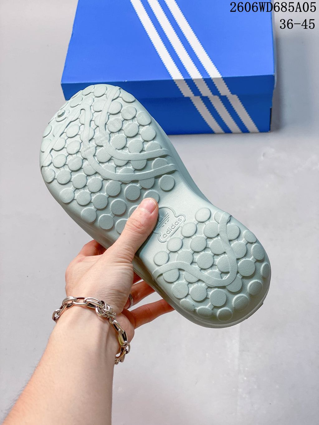 Textured outsole of a light blue Adidas mule shoe