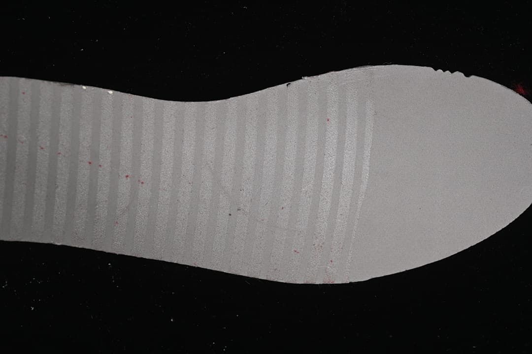 Underside of a white sneaker insole.