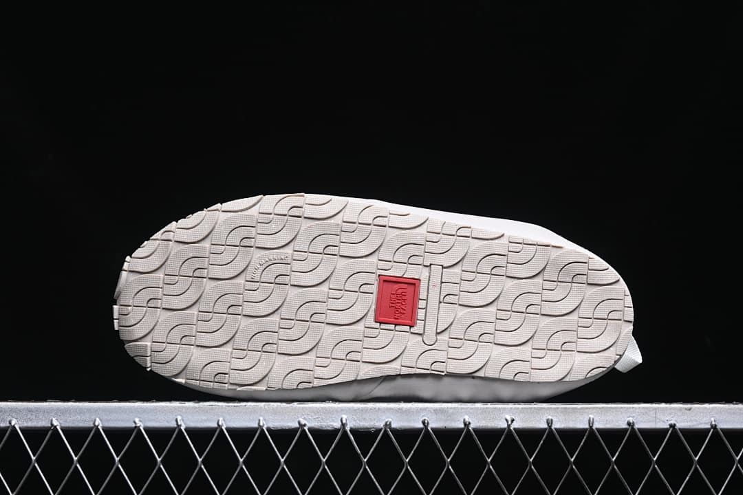 Underside view showing the patterned outsole and central logo detail.
