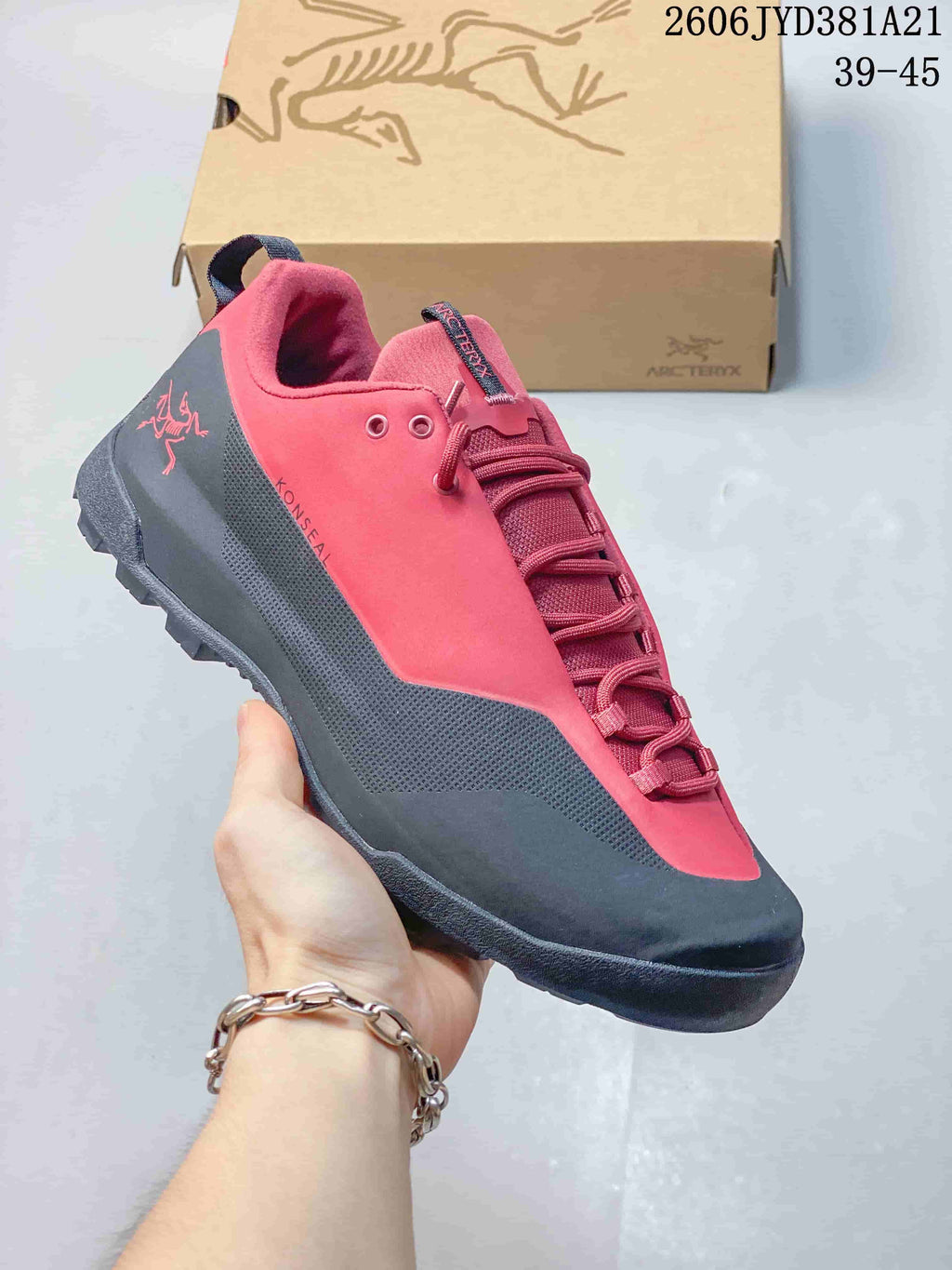 Red and dark gray Arc'teryx Konseal shoe with a lace-up closure