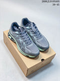 Pair of gray SREGIEK Norvan 2556 GTX trail shoes with pale mint accents on a box