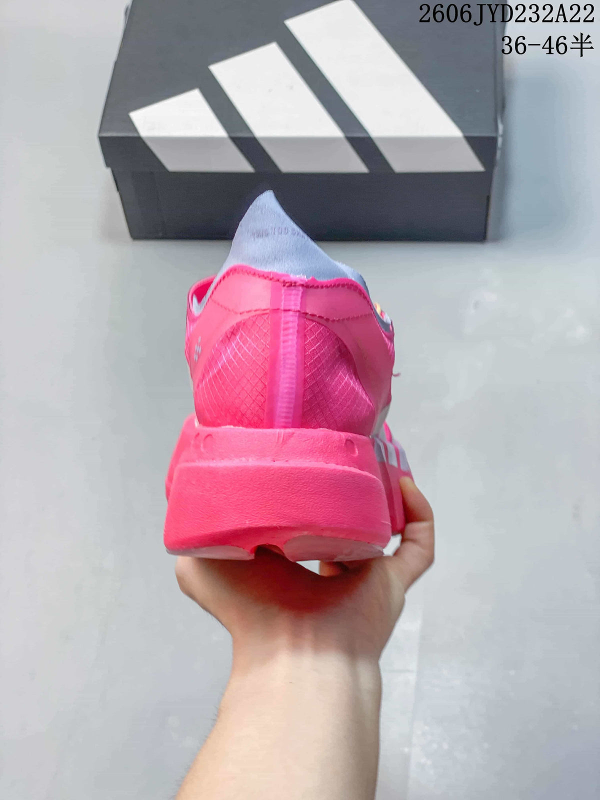 Rear view of a pink running shoe with a sculpted heel.