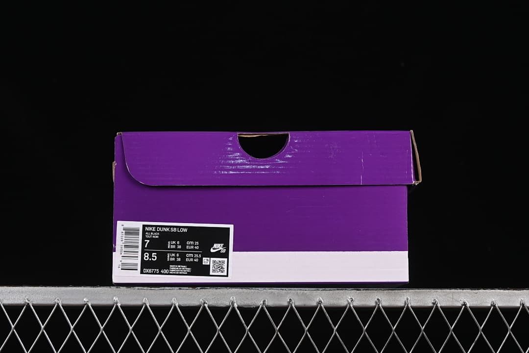 Purple-and-white shoe box with a label identifying Nike Dunk SB Low and style code DX6775-400
