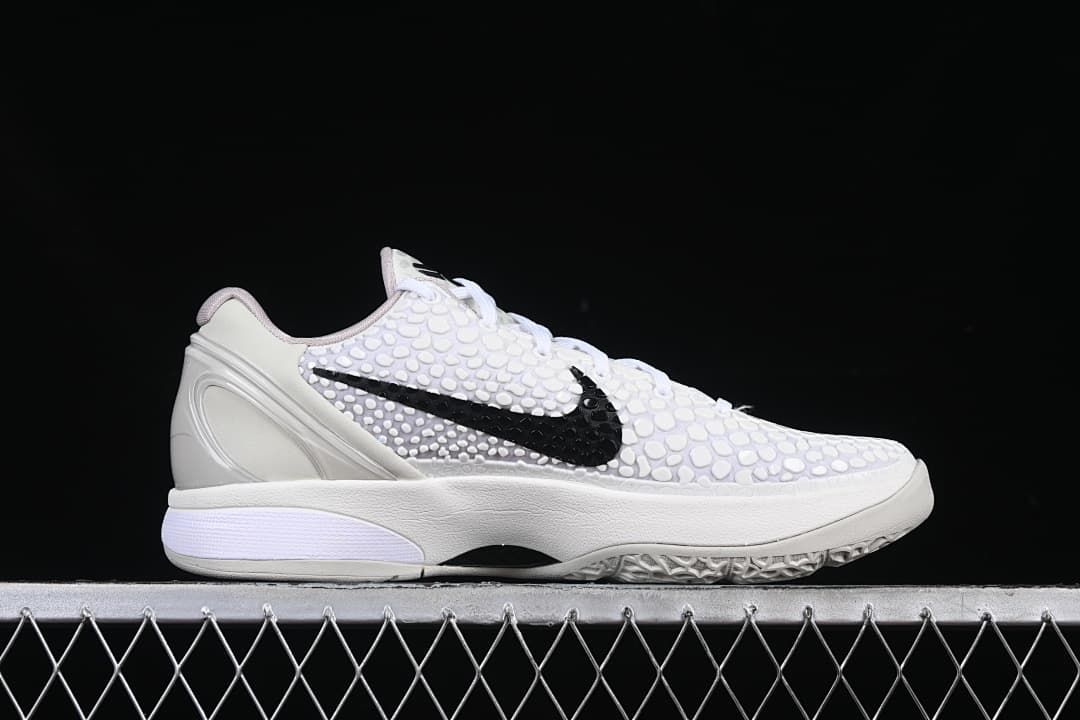 Side profile of the white shoe with black Swoosh