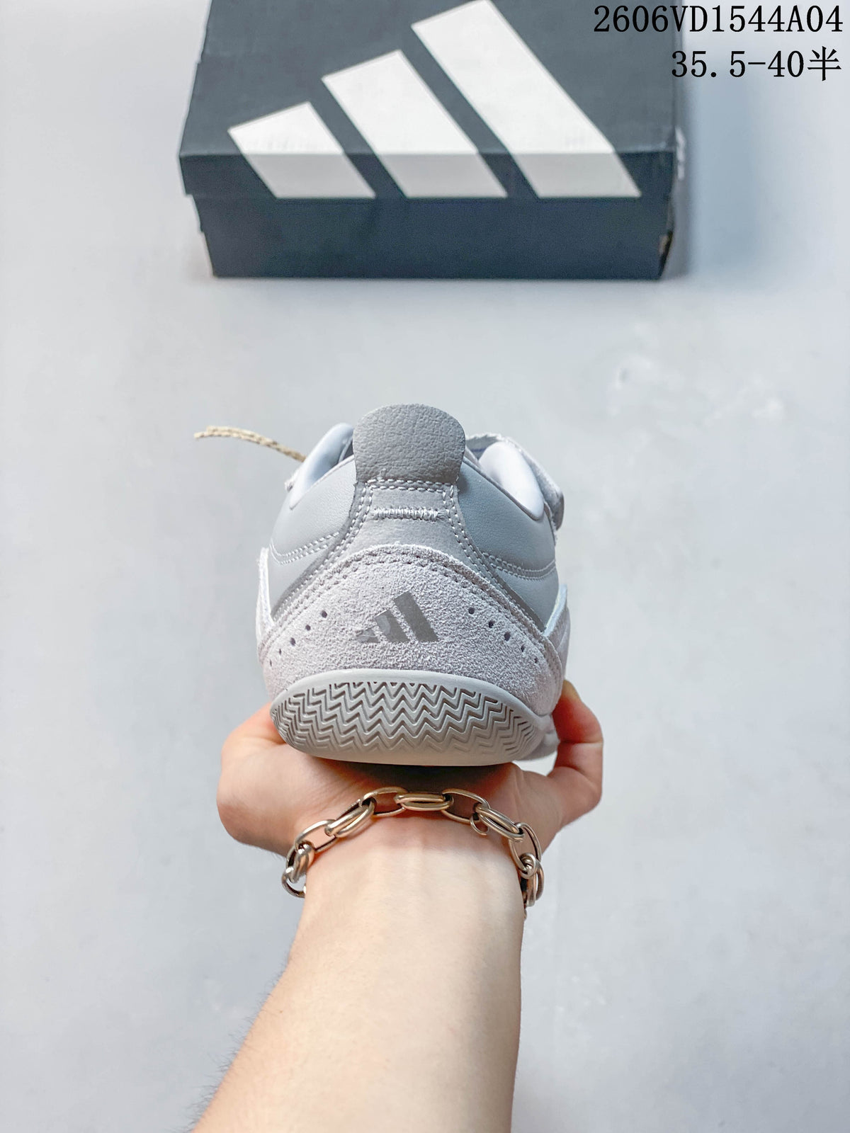 Rear view of the light gray Adidas sneaker showing its heel panels and outsole