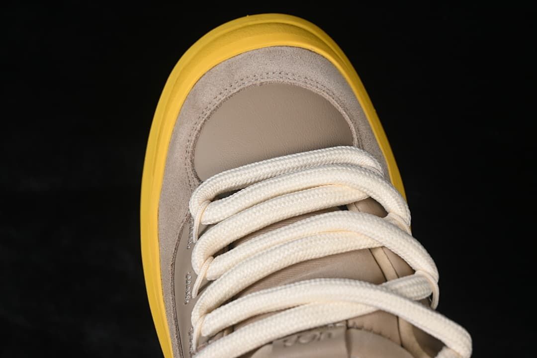 Top view of the sneaker toe and cream laces