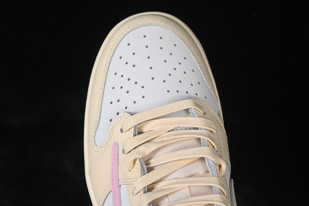 Top-down view of the perforated white toe box and cream laces