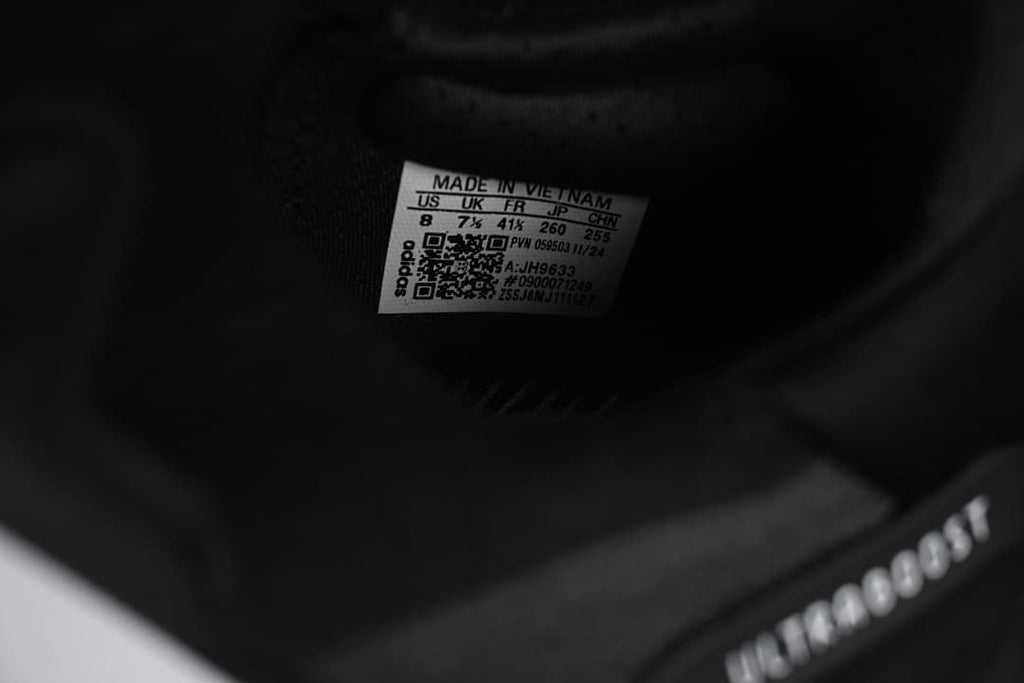 Close-up of the inner shoe label showing sample size information and model code