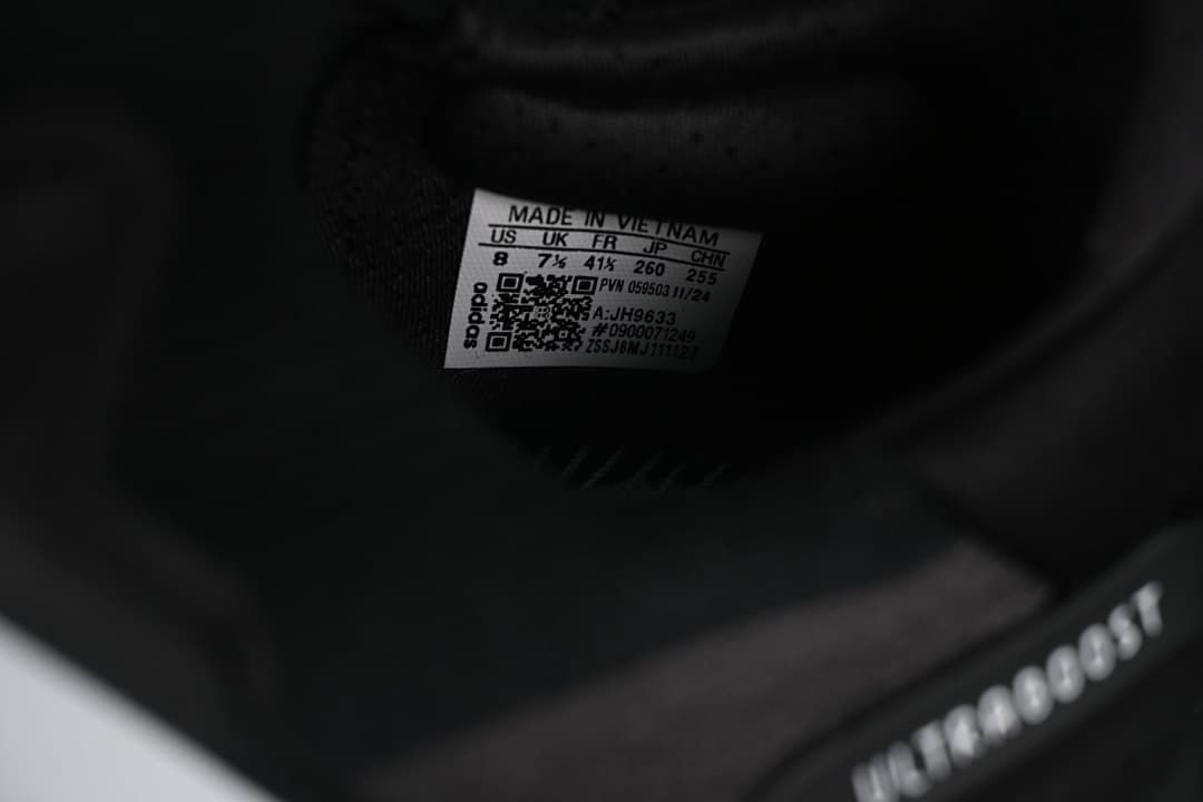 Close-up of the inner shoe label showing sample size information and model code