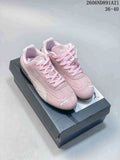 Pair of pink Puma Speedcat OG sneakers with light-colored side stripes and a dark outsole