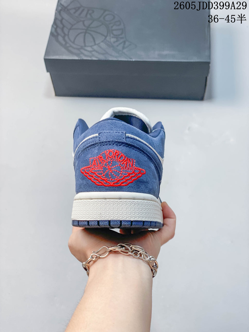 Rear view of the blue sneakers with red heel embroidery