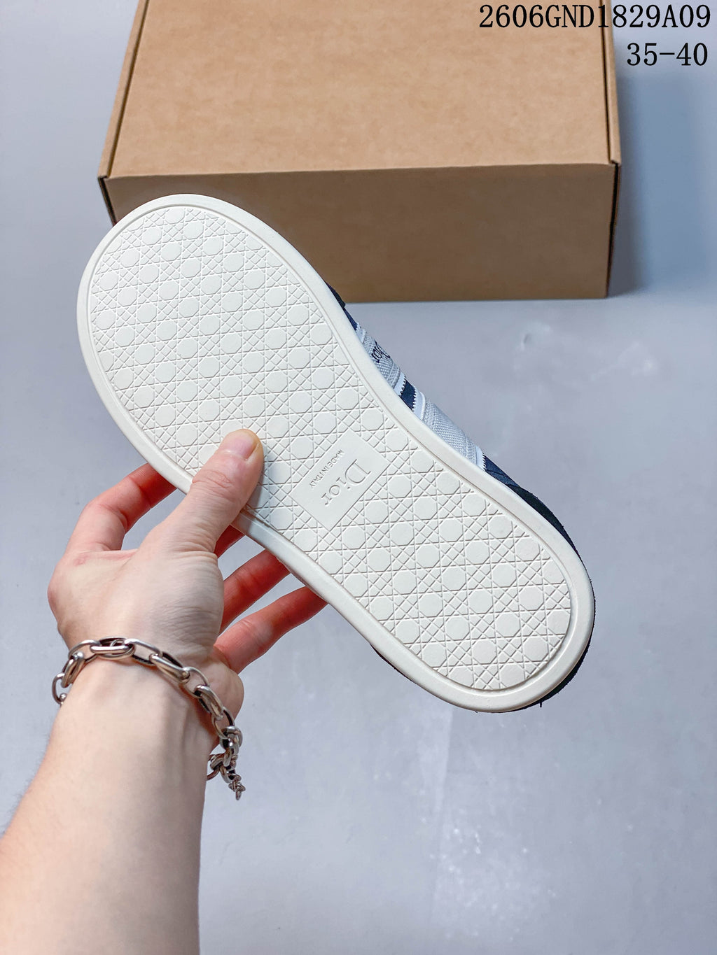 Close-up of the light-colored patterned outsole of a navy sneaker.