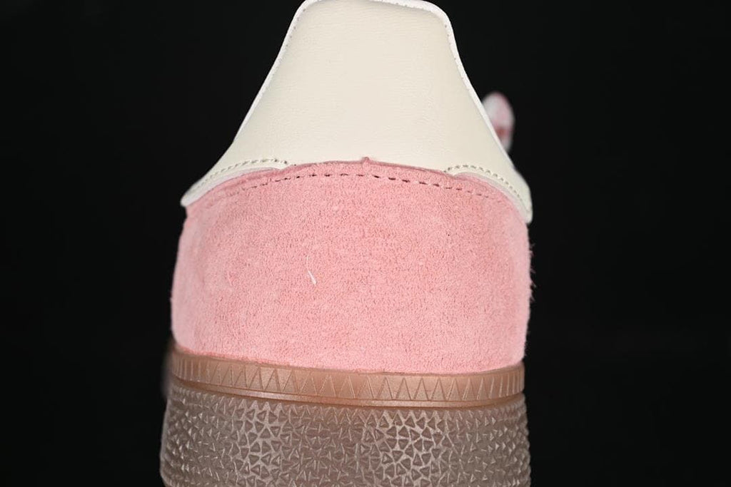Rear view showing the pink heel panel and off-white heel tab