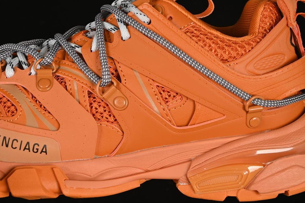Detail of the sneaker’s orange layered side panels and mesh sections