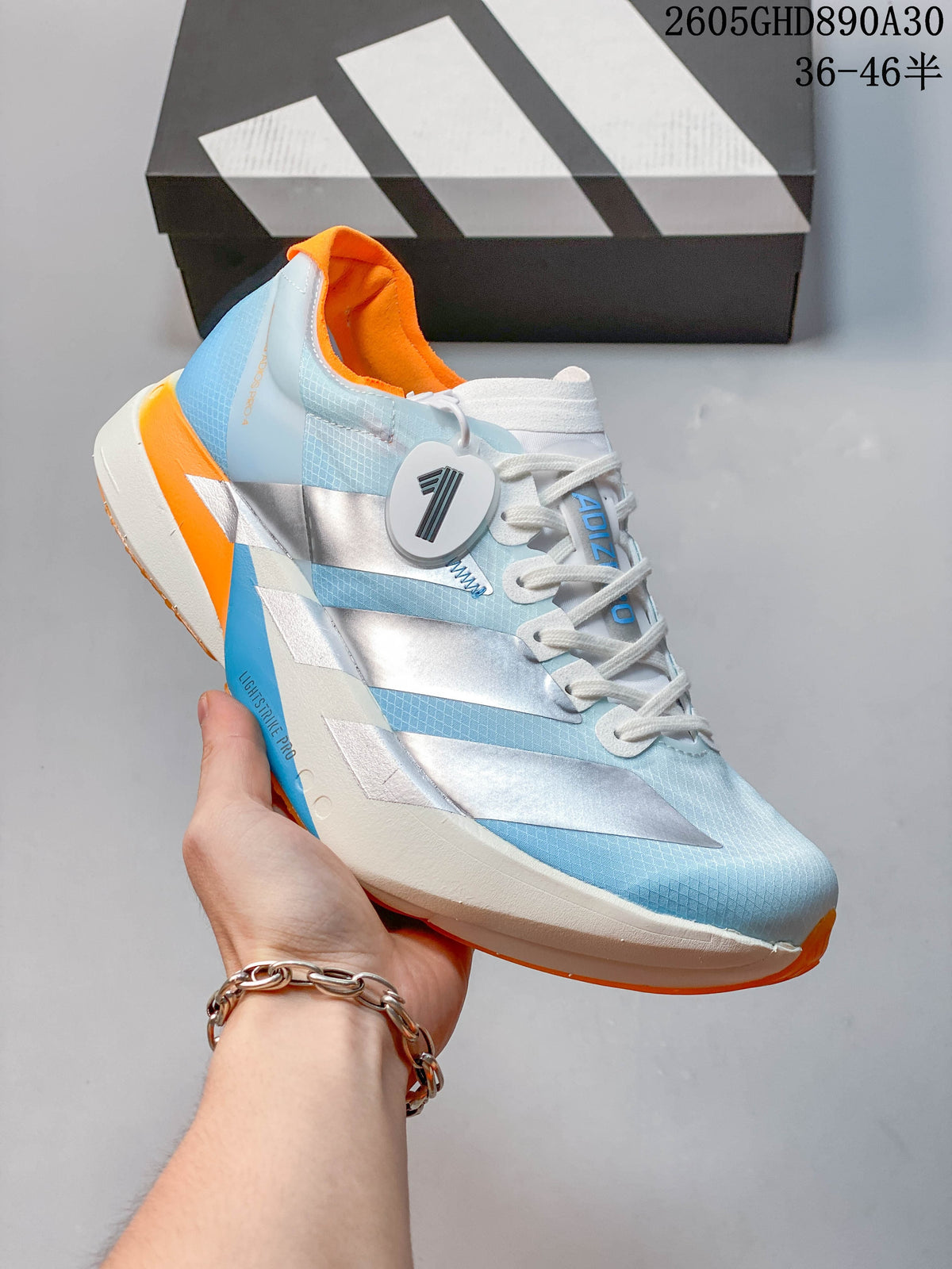 Angled side view highlighting the shoe's silver stripes and orange details