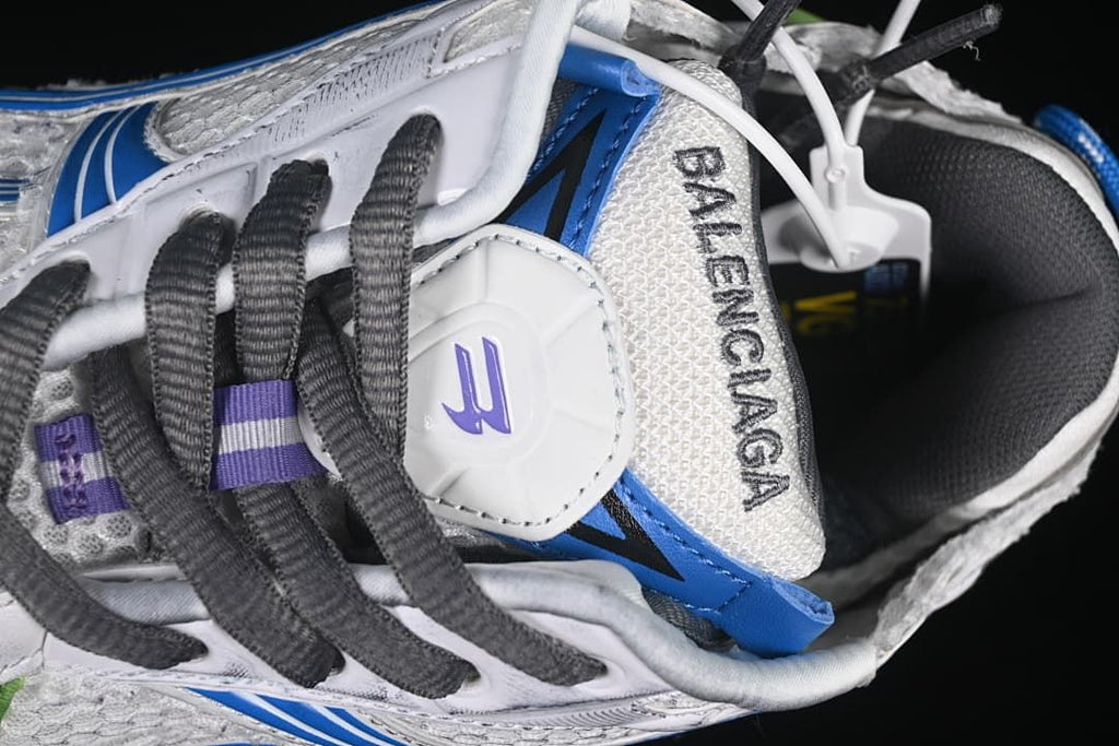 Top detail of the sneaker tongue, laces, and visible branding
