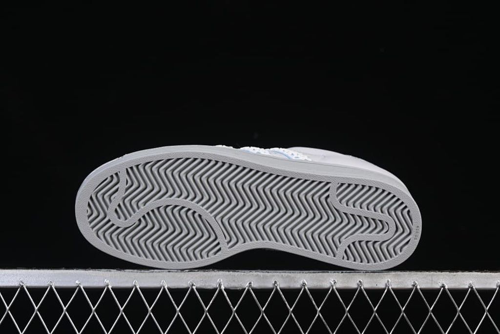Underside view showing the grey outsole with a herringbone tread pattern.