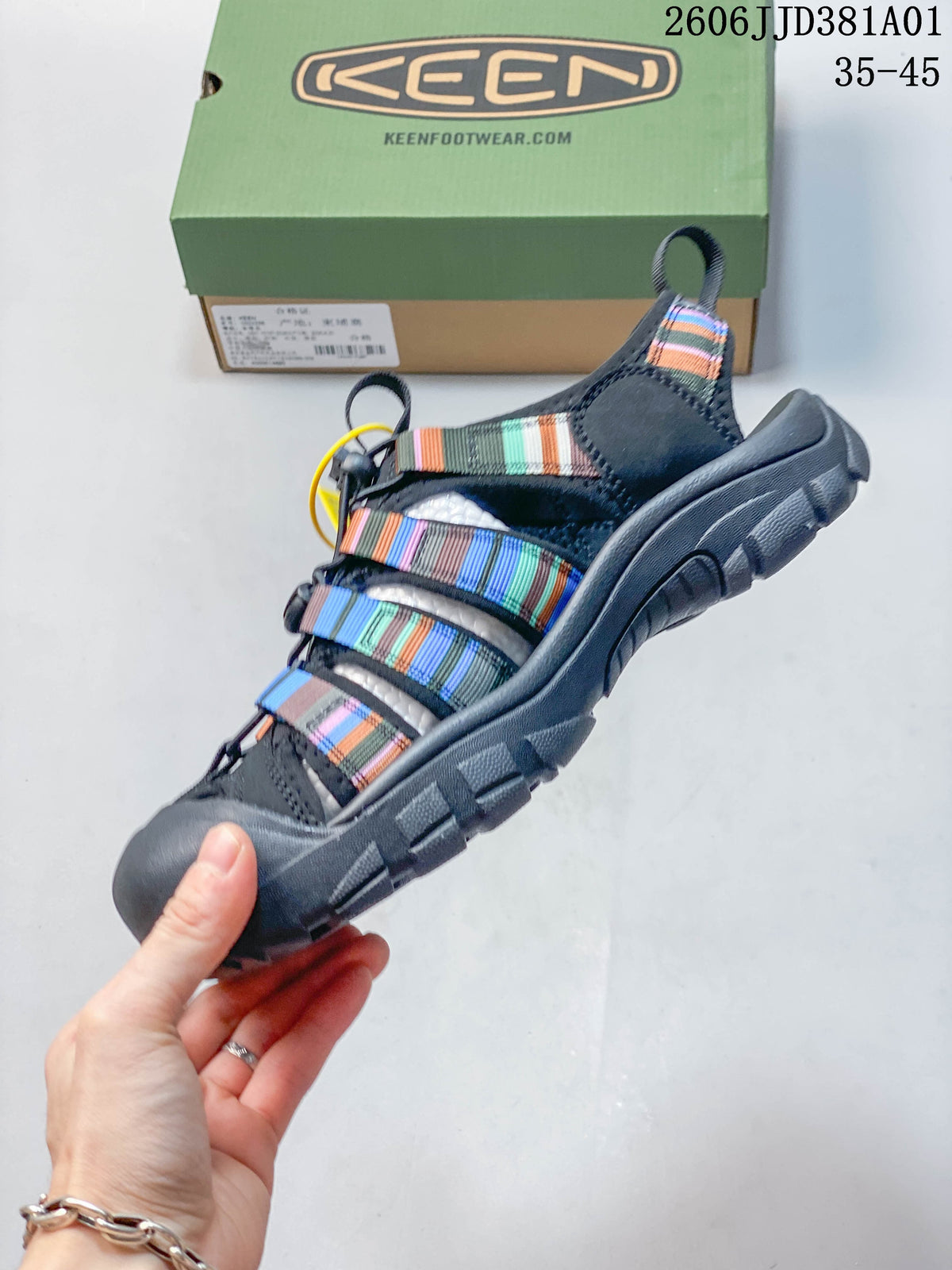 Side view of a closed-toe sandal with multicolor striped straps and a dark gray sole.