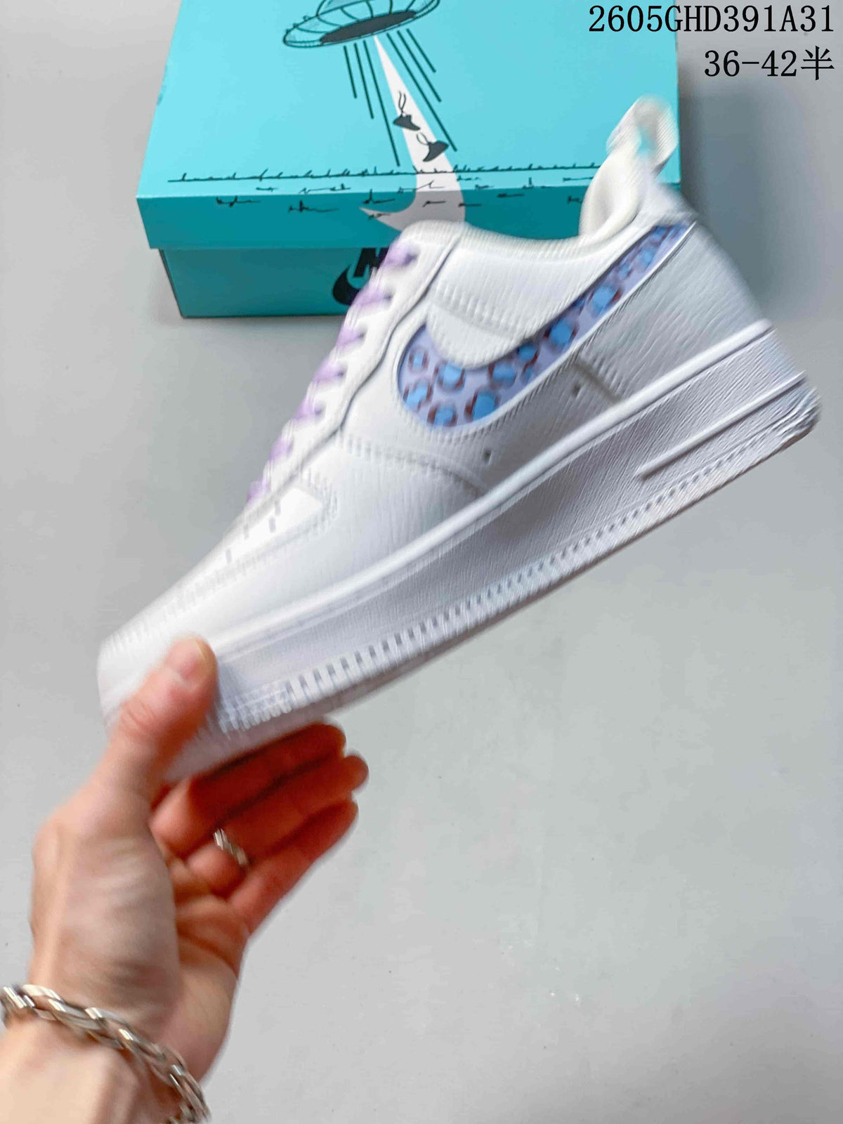 Side view of a white Nike Air Force 1 Low sneaker showing its colorful patterned panel and white sole