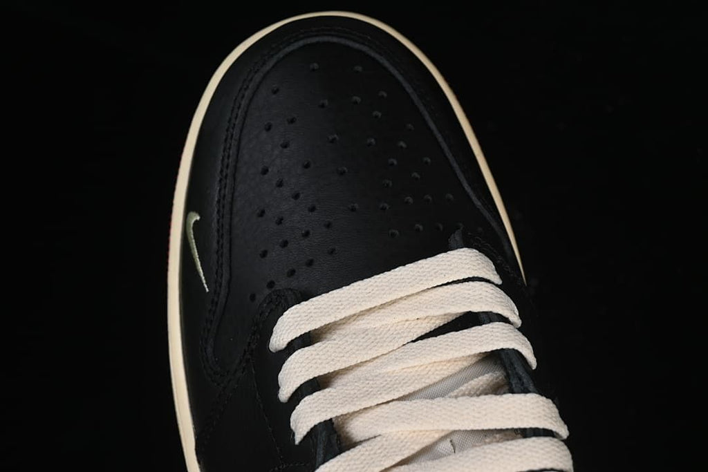 Top view of the perforated black toe and cream laces