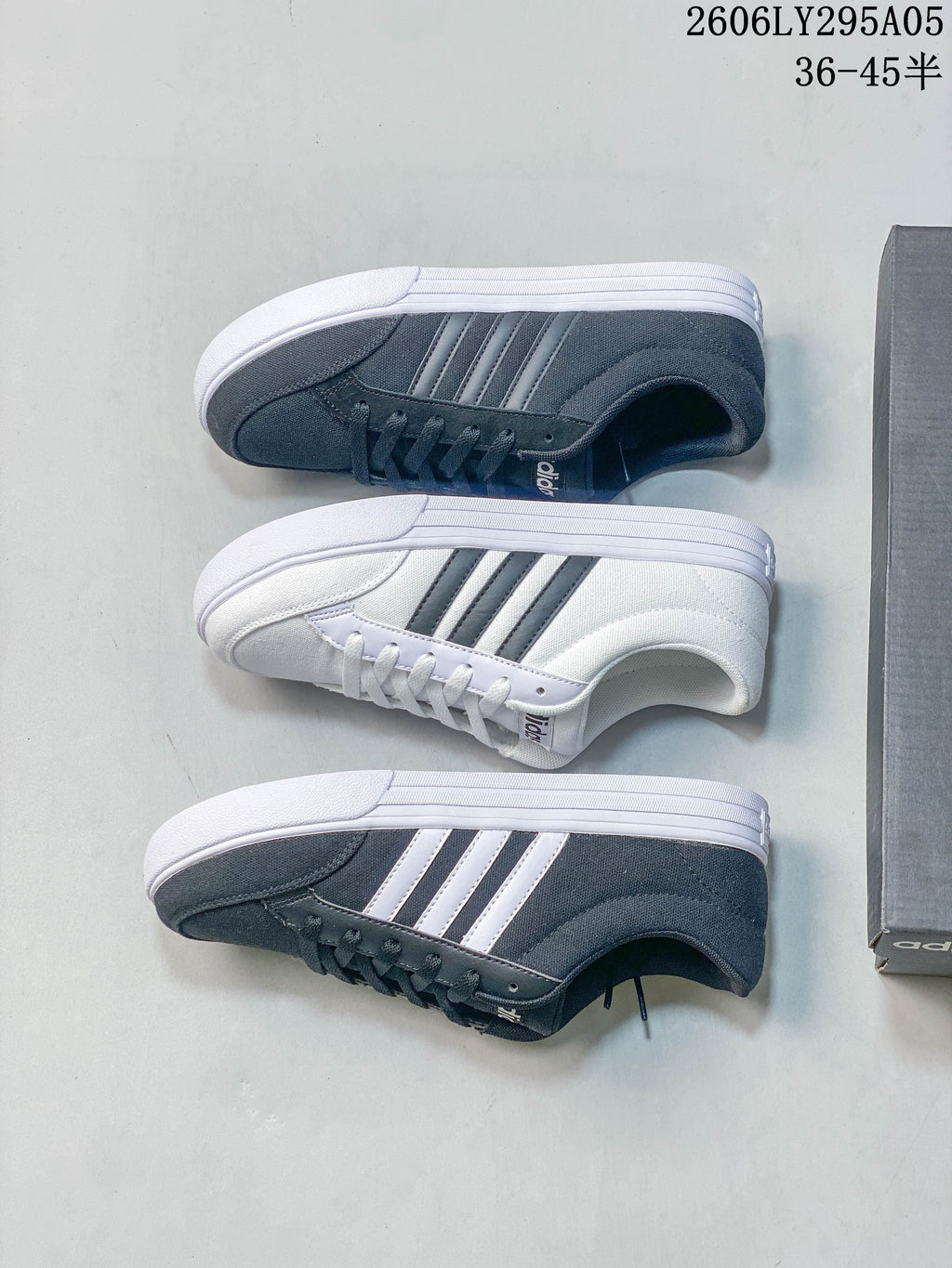 Three adidas low-top sneakers shown from above, including white and charcoal gray colorways.