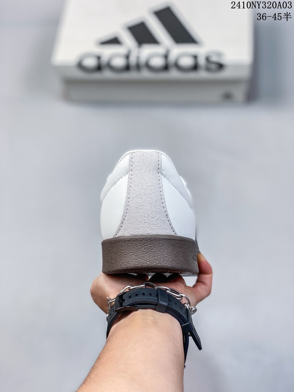 Rear view showing the gray heel panel and brown sole of the Adidas sneaker