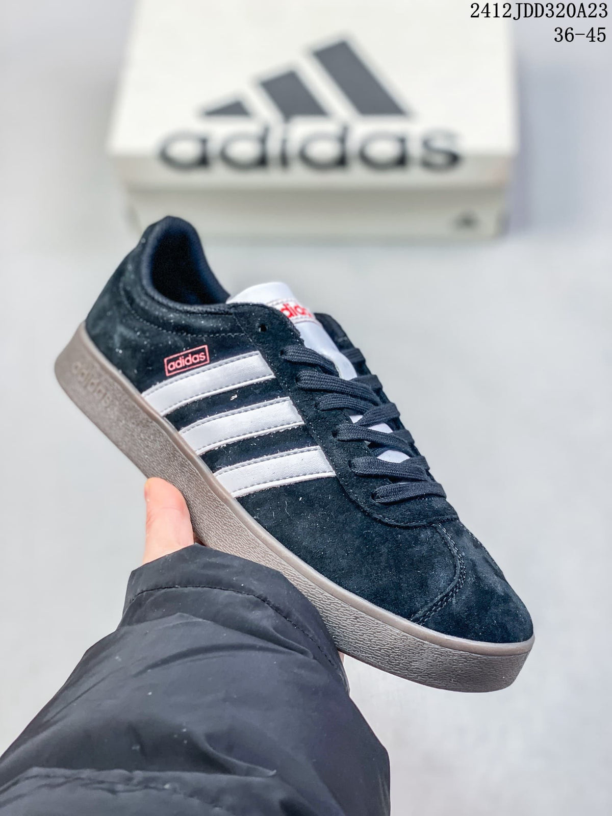 Angled side view of a black Adidas VL Court Classic sneaker with white stripes and gray sole