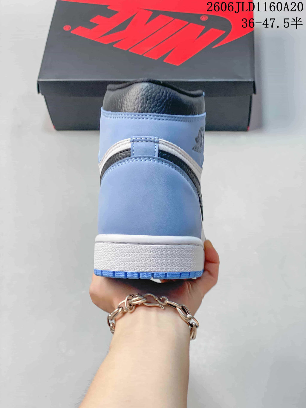 Rear view of a blue, white, and black high-top sneaker