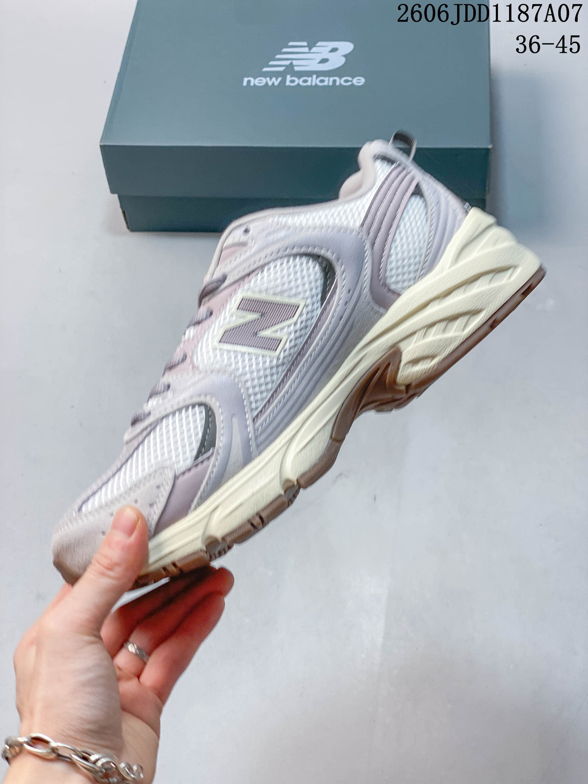 Side view of the layered mesh sneaker with gray and pale pink details