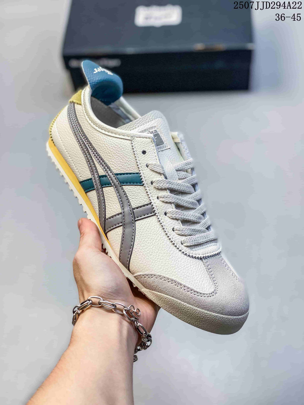Angled side view of the cream sneaker with gray side stripes and teal accents
