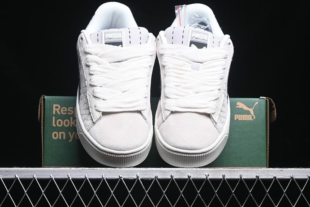 Front view of the pair with light-colored uppers and wide laces.