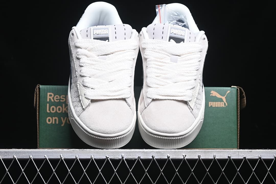 Front view of the pair with light-colored uppers and wide laces.
