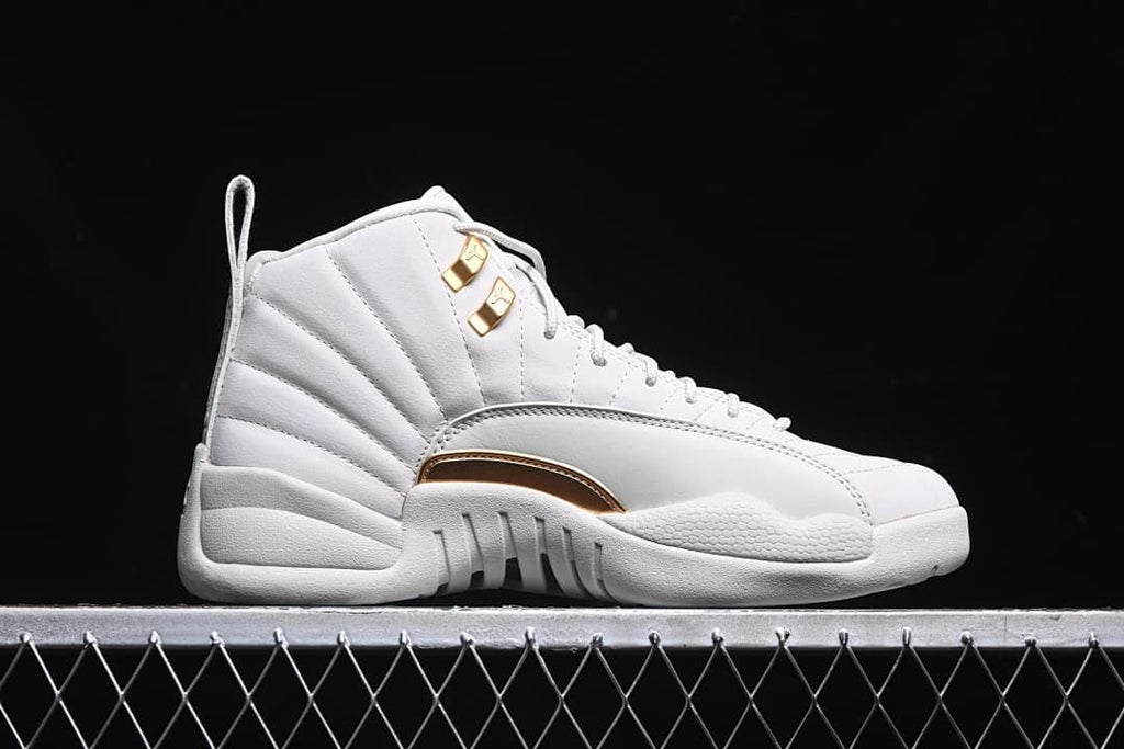 Outer side view of a white high-top sneaker with gold-tone accents