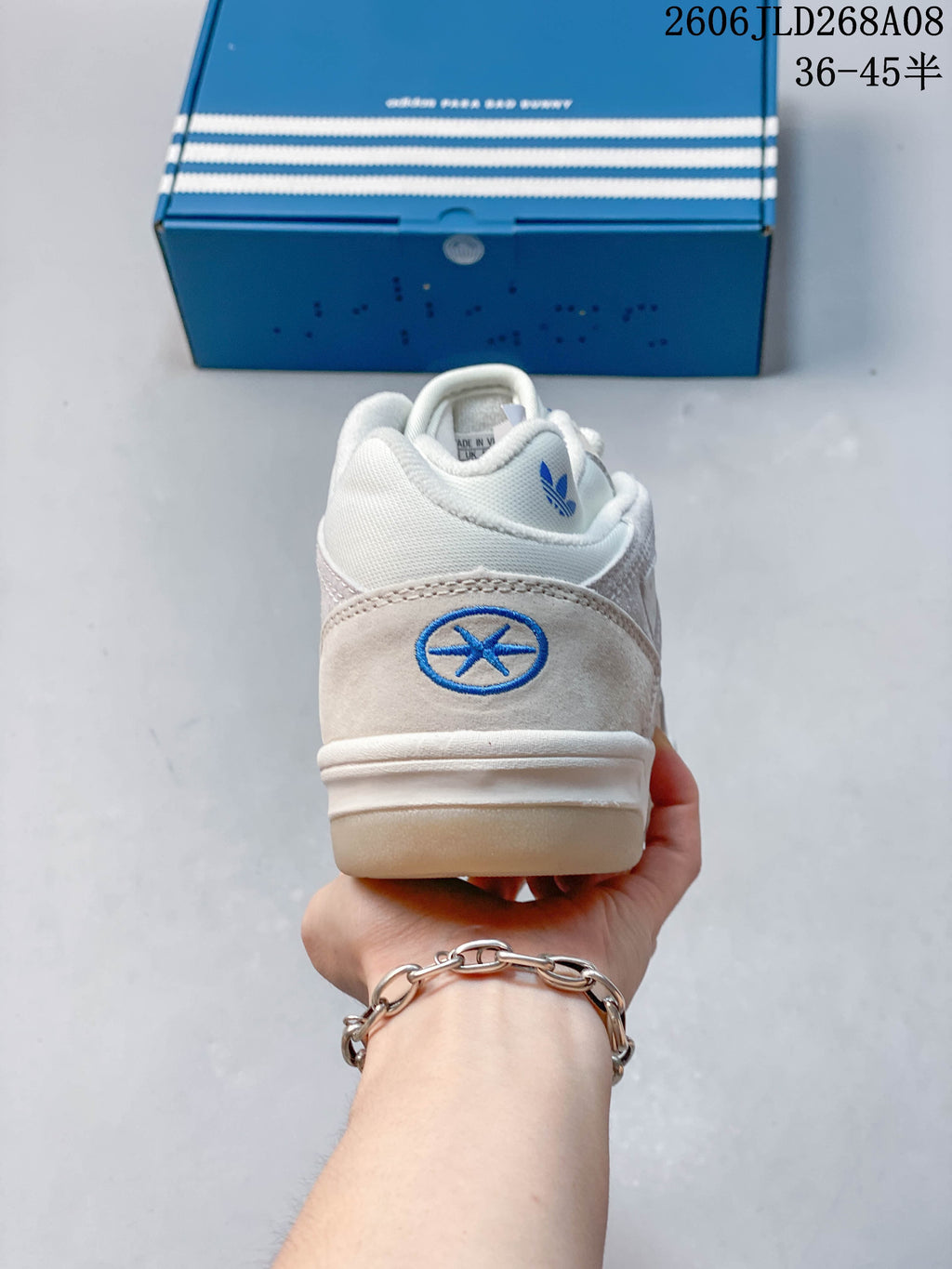 Rear view showing the blue heel emblem and adidas trefoil on the tongue