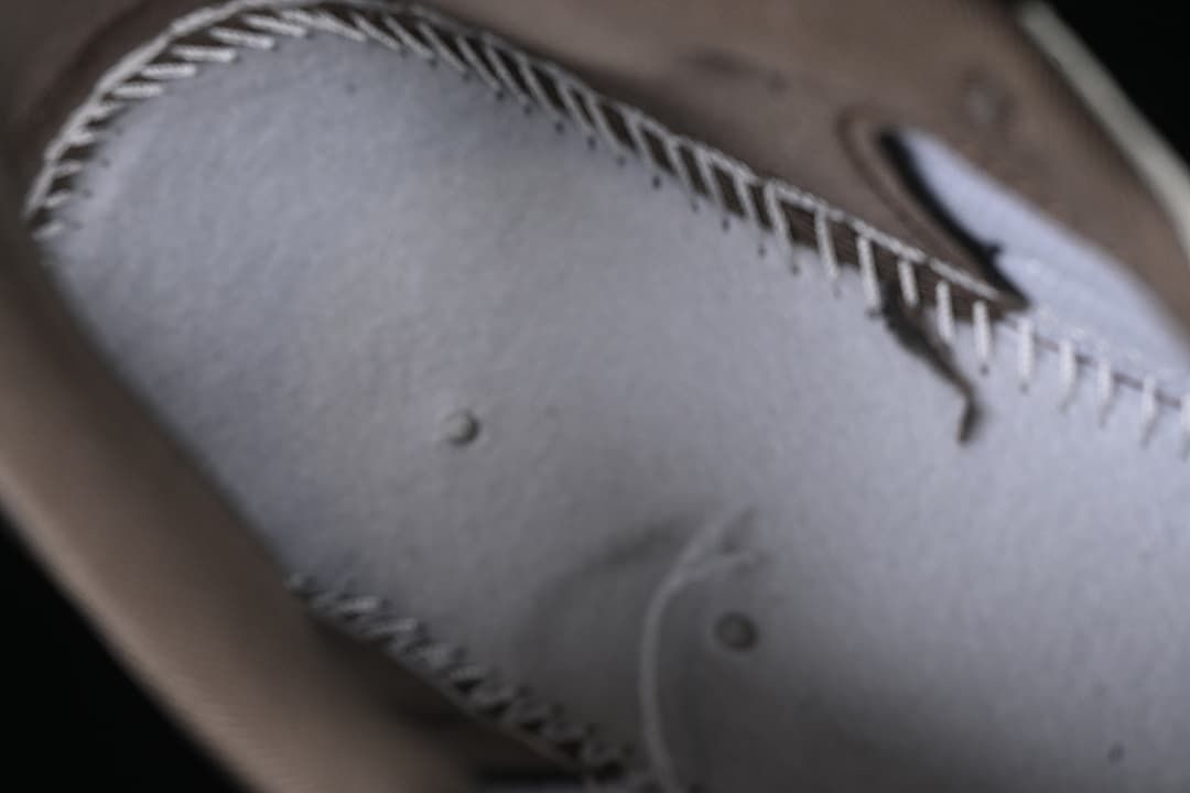 Close-up of stitching and construction on the sneaker upper.