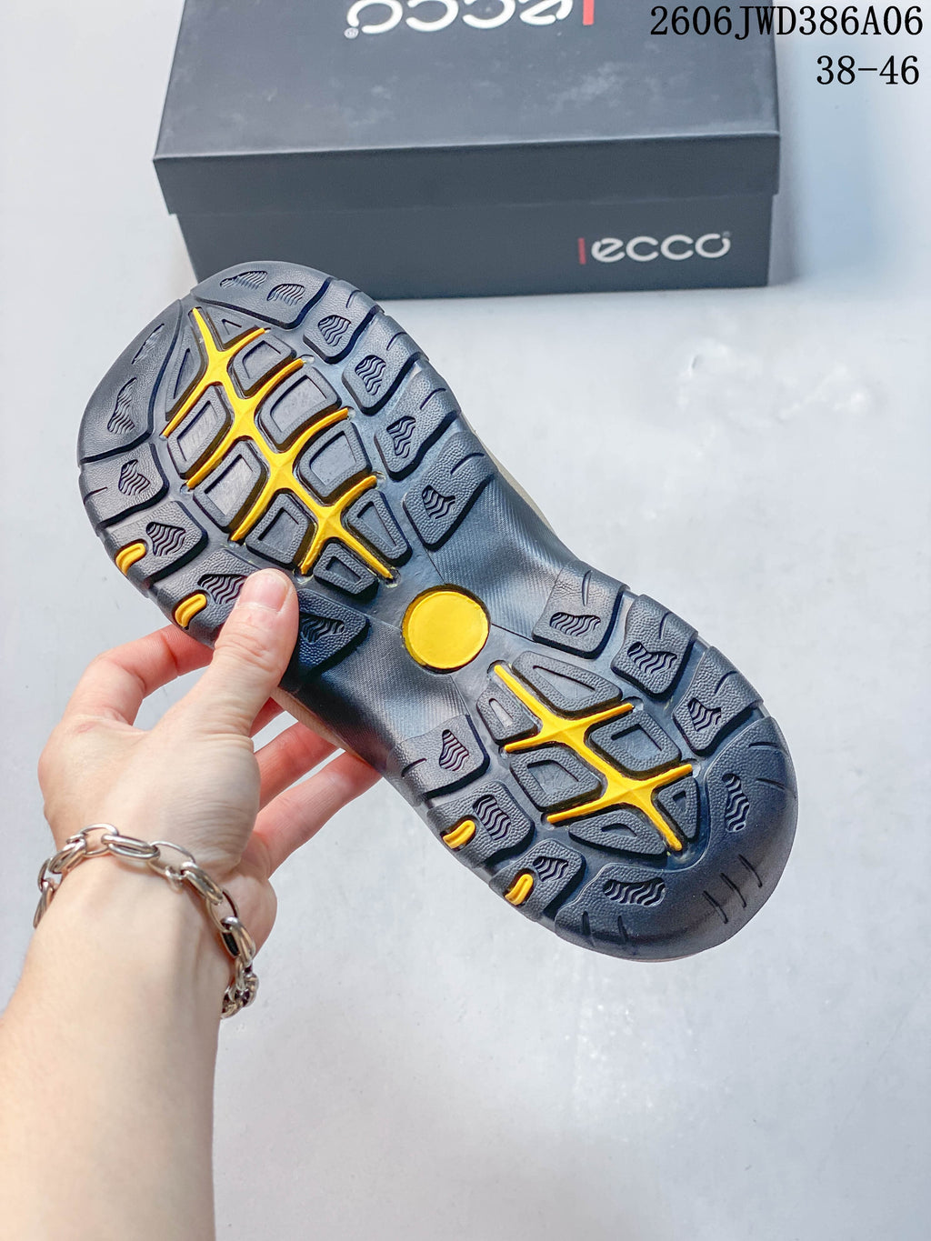 Close-up of the sandal outsole with a patterned tread and yellow accents.