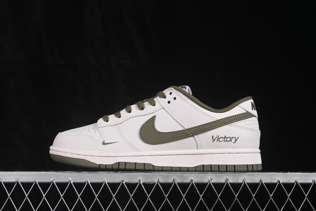 Side profile highlighting the olive Swoosh, olive collar, white upper, and Victory detail near the heel.