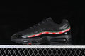 Side view of a black Nike Air Max 95 SP with red-and-green Undefeated side detailing