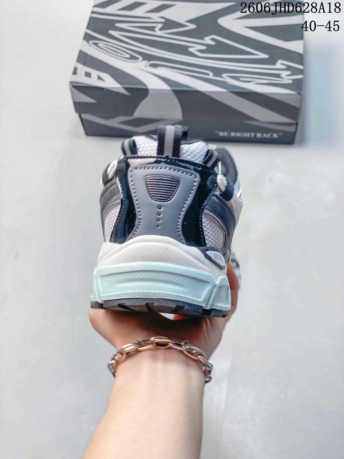 Rear view of the sneaker showing layered heel panels and a chunky sole