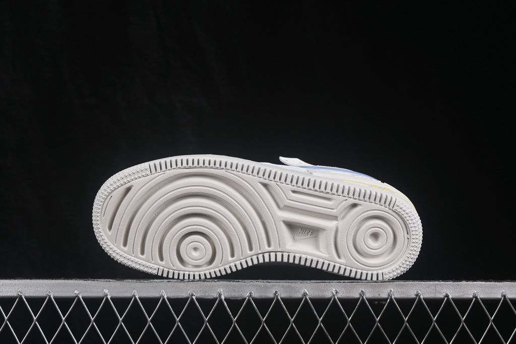 Side view of the sneaker outsole showing circular grooves and a textured rubber traction pattern.