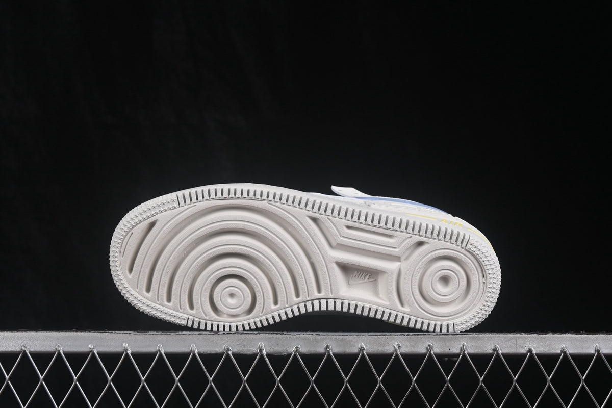 Side view of the sneaker outsole showing circular grooves and a textured rubber traction pattern.