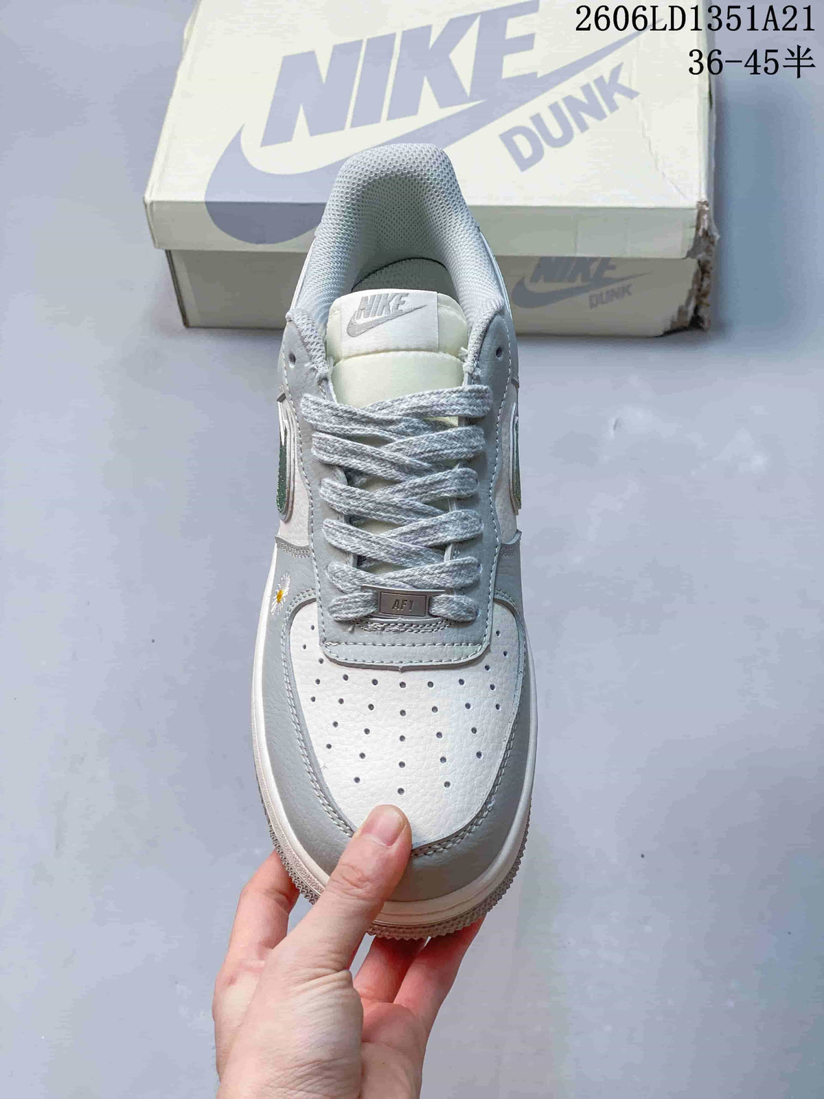 Front view showing the perforated toe, gray laces, and AF1 lace tag