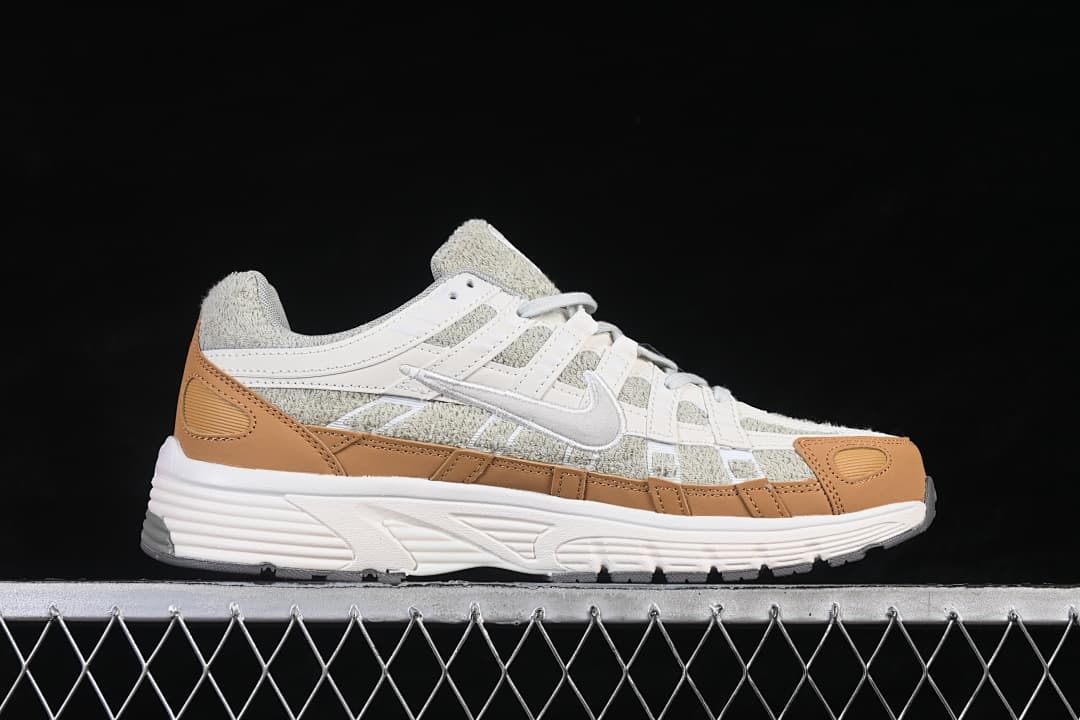 Side profile of the Nike P-6000 sneaker with layered gray, white, and tan panels