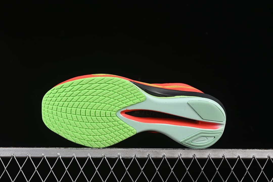 Underside view showing the green patterned outsole and sculpted midsole.